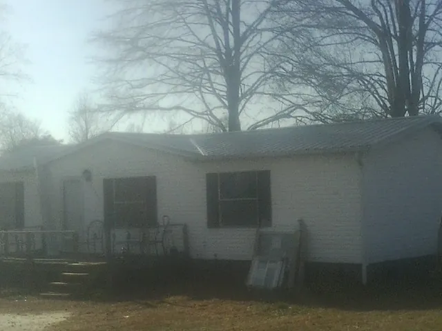 New metal roof on a white painted brick home on a foggy morning in Hawaiian Gardens