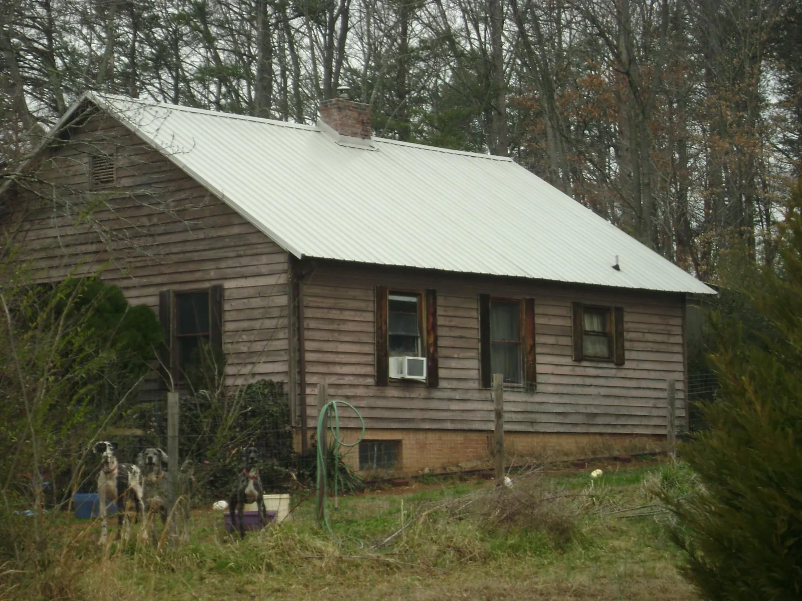 White metal roof on an old wood sided farmhouse, from a Metal Roof Installation job in Hawaiian Gardens
